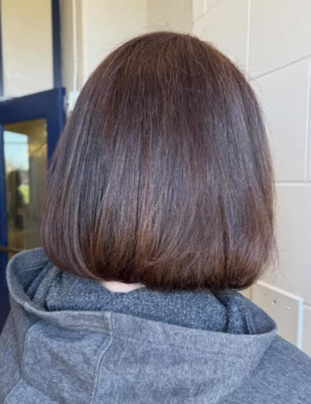Grey coverage colour, and a one-length bob with texturizing on the ends for a soft look. Round-brushed to smooth natural curl pattern.